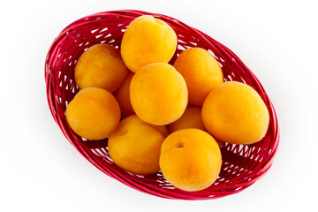 organic apricots in a pink basket