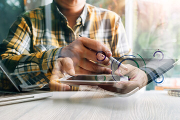 Businessman holding tablet and checking analyzing sales data growth graph chart and stock market on global networking. Business strategy, planning and digital marketing on blue background.