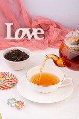 tea ceremony, brewing black light tea, from a teapot in a cup