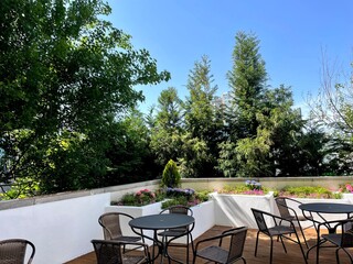 A large open-air terrace on the roof-top with lounge space
