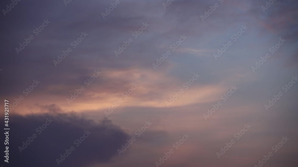 Wall mural clouds move in the sky at dusk.