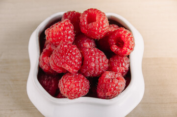 fresh raspberries in a small white bowl.