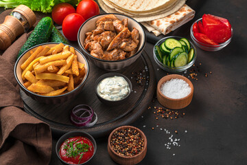 Lunch, or ingredients for shawarma, burritos, gyros on a brown background. Side view, copy space.