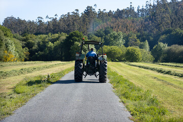 Scene of an old tractor seen from behind on a road in a rural area. Galicia, Spain © Formatoriginal