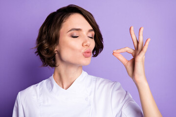 Photo of charming happy young woman make gesture chef kiss tasty meal isolated on violet color background - obrazy, fototapety, plakaty