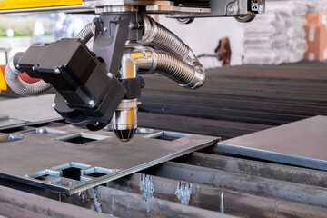 Automatic cnc plasma cutting machine working with sheet metal at factory, plant. Metalworking,...