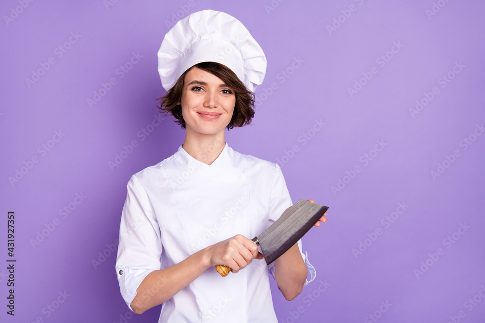 Sticker Photo of positive happy nice young chef woman hold butcher knife smile isolated on purple color background