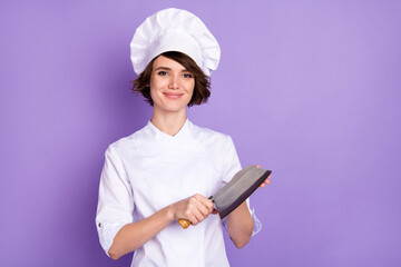 Photo of positive happy nice young chef woman hold butcher knife smile isolated on purple color background - Powered by Adobe