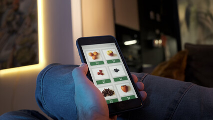 Ordering food, vegetables and fruits online using smartphone app close up. Food delivery mobile app I created. 