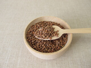 Brown mountain lentils in a wooden bowl