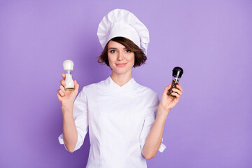Photo of charming happy nice young woman hold hands spice chef hotel isolated on purple color...