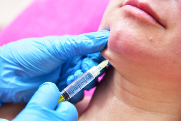 Beautician makes beauty injections. Anti-aging facial skin care, anti-wrinkle and sagging skin. 
