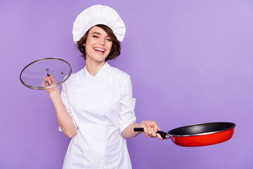 Portrait of attractive cheerful chef frying hot fresh breakfast lunch meat gourmet isolated over...