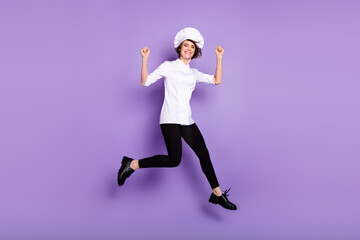 Full length body size view of lovely cheerful girl chef jumping having fun walking isolated over bright violet purple color background
