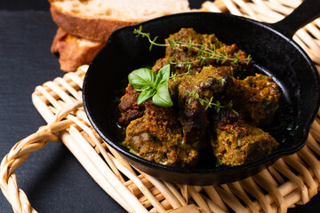 Food concept homemade spot focus roasted grilled satay beefs in skillet iron pan with copy space