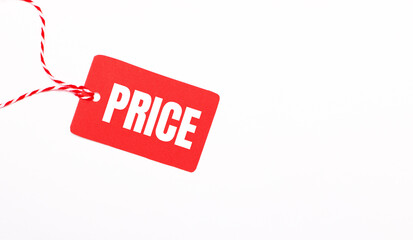 The inscription PRICE on a red price tag on a light background. Advertising concept. Copy space