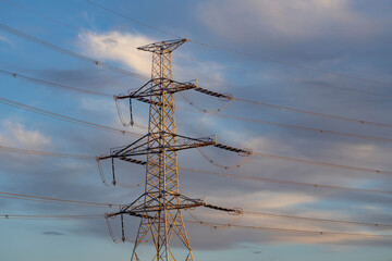 high voltage electric pylon with blue sky