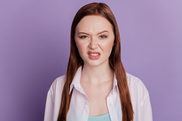 Photo of young girl disgusted dislike bad smell isolated over violet background