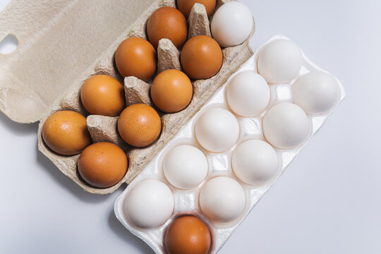 Brown and white eggs in cardboard boxes