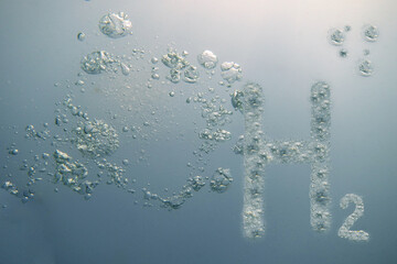 h2 hydrogen letters in light blue water with many bubbles