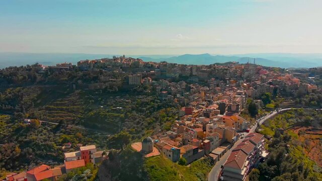 POI, drone aerial footage of the town of Centuripe in eastern Sicily, with an overview of the Etna active volcano, during early spring in Italy.