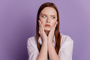 Portrait of bored tired lady hands cheeks look side empty space on purple background