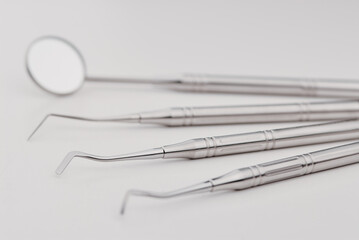 Basic dentist tools on white table.