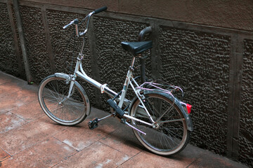Fototapeta na wymiar Bicycle leaning against the wall . Ecological transport for the city . Healthy lifestyle concept