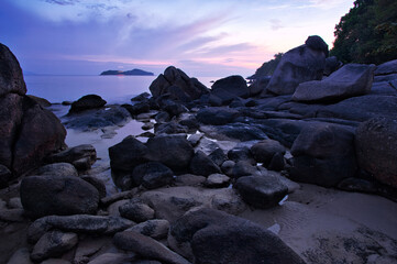 Big rocks and stones at the sea beach on daybreak.