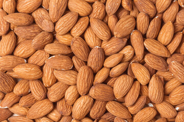 Top view pile of roasted almaonds, Nuts are low in carbs but high in healthy fats, protein and fiber. close-up shot.