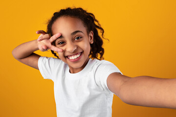 Black girl taking a self portrait, point of view