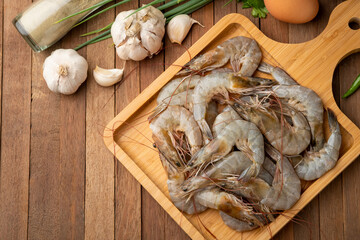 Close up Fresh raw shrimp (Litopenaeus vannamei) on wooden plate.Top view.