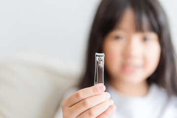 clean nails.kid child girl cutting nails using stainless steel nail clipper at home.Hygiene.virus bacteria in nails.Toe nail cutting with a cutter.sanitizer hand.coronavirus covid19.skin care.