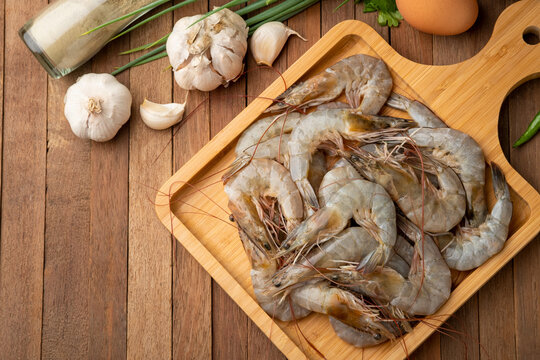 Close up Fresh raw shrimp (Litopenaeus vannamei) on wooden plate.Top view.