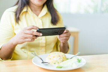 woman taking photo food with smartphone before eat at home.Thai asian senior woman live streaming.60 years old women.Grandmother grandparent.Social media, health, Technology, video call, take a photo.
