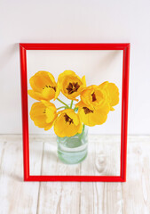 bouquet of tulips in a vase inside a picture frame