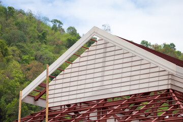 Fototapeta na wymiar With white synthetic wood made from fiber cement, builders attached the roof instead of wood. Get a beautiful pattern like wood But durable, prevent eating termites, and reduce costs.