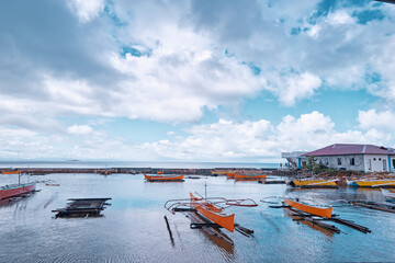 Traditional fishing boats harbour at rainy day. Siargao, Philippines.