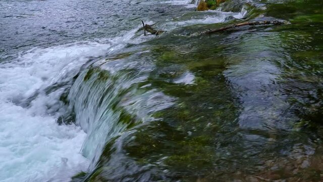 Flowing water stream 4K video. Creek, torrent, beauty of nature.