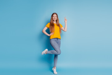 Fototapeta na wymiar Portrait of cheerful dream lady show v-sign wear casual clothes on blue background