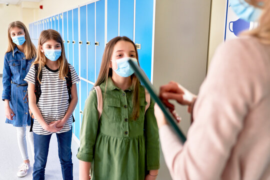 Students waiting in line for class during a pandemic - Powered by Adobe