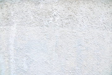 The background is made of rugged, gray-colored plaster walls.