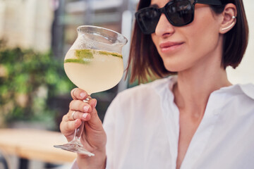 Pritty girl in glasses drinking cocktail