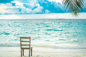 Panoramic view of a tropical beach with palm trees, turquoise waters and blue sky in the Maldives, Indian Ocean