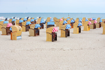 Basket chair on the beach. Hooded wicker chairs on a beach, Germany vacation concept.