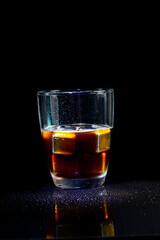 Cold americano decoration with stainless steel cubes ice  on a black table.