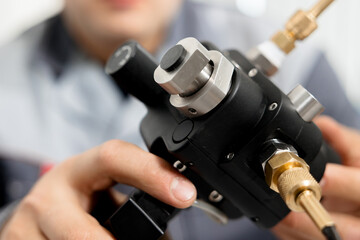 The metrology and standardization laboratory specialist connects the device under test pressure...