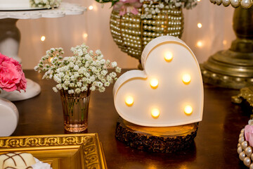 Table decorated with heart lamp.