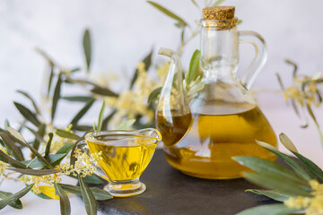 Olive branch and olive oil bottle isolated on white.