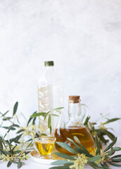 Olive branch and olive oil bottle isolated on white.